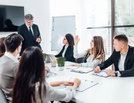 boss-businessman-holding-papers-hands-and-smiling-young-team-of-coworkers-making-great-business-discussion-in-modern-coworking-office