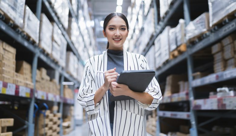 portrait-of-asian-woman-business-owner-using-digital-tablet-checking-amount-of-stock-product-inventory-on-shelf-at-distribution-warehouse-factory-logistic-business-shipping-and-delivery-service