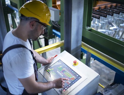 factory-worker-monitoring-industrial-machines-and-production-remotely-in-control-room