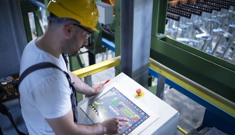 factory-worker-monitoring-industrial-machines-and-production-remotely-in-control-room