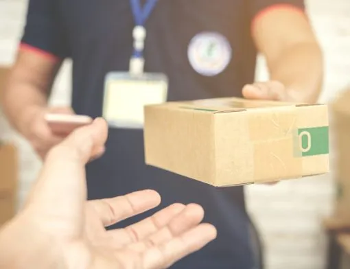 delivery-man-smiling-and-holding-a-cardboard-box