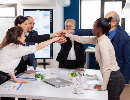 Cheerful overjoyed business people in conference room celerating